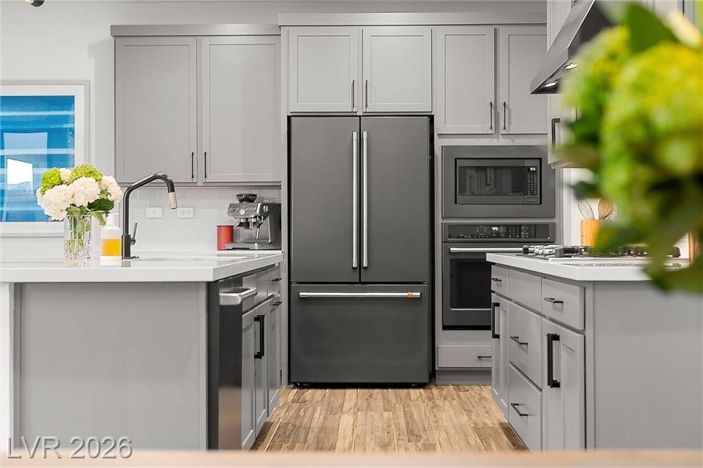 Black stainless refrigerator, built-in oven and microwave at 2702 Marchetti Place