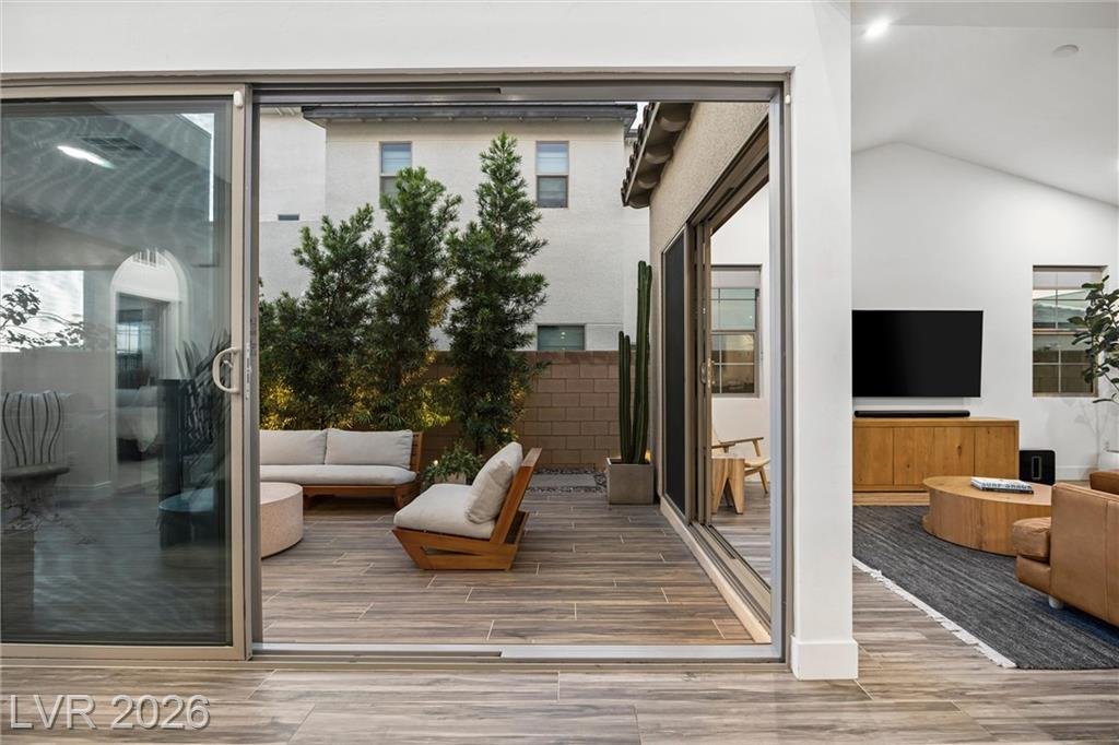 Floor-to-ceiling glass sliders at 2702 Marchetti Place framing the courtyard lounge