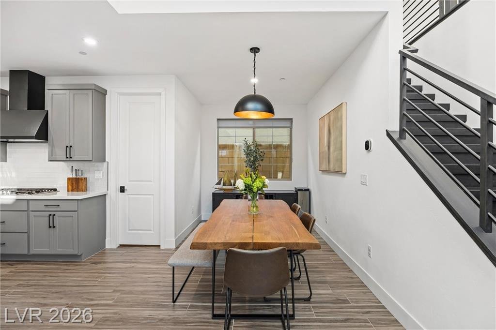 Formal dining area with a live-edge table beside the staircase