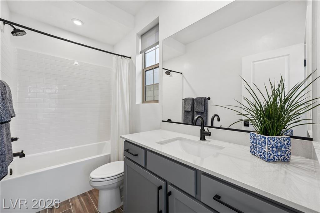 Downstairs guest bath at 2702 Marchetti Place with a tub-shower and quartz vanity