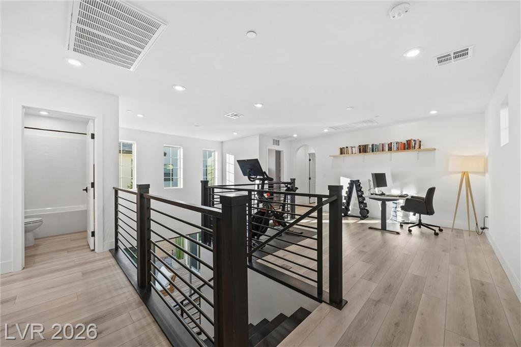 Upstairs loft at the top of the stairs with an office desk