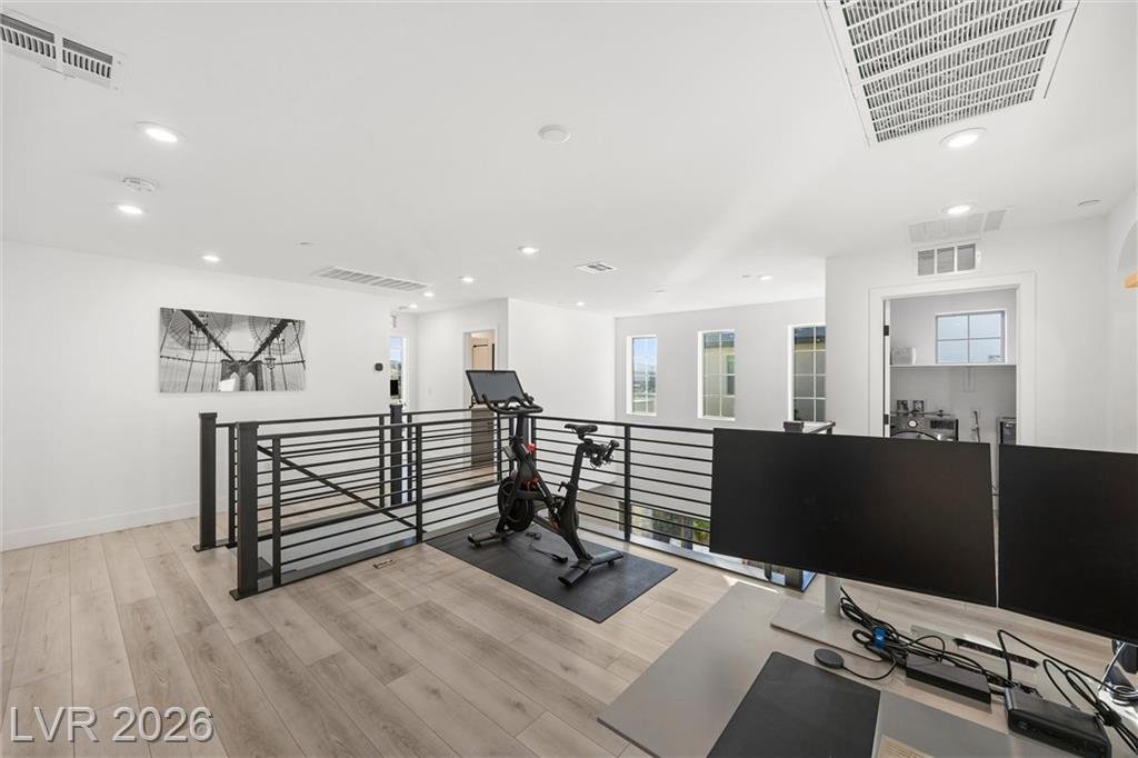 Loft at 2702 Marchetti Place set up with an exercise bike and desk