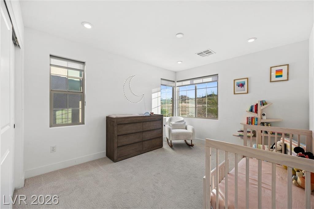 Secondary bedroom set up as a nursery with corner windows