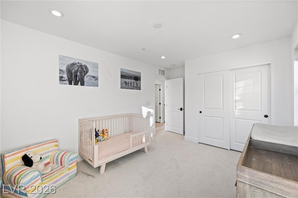Nursery bedroom with a crib and double closet doors
