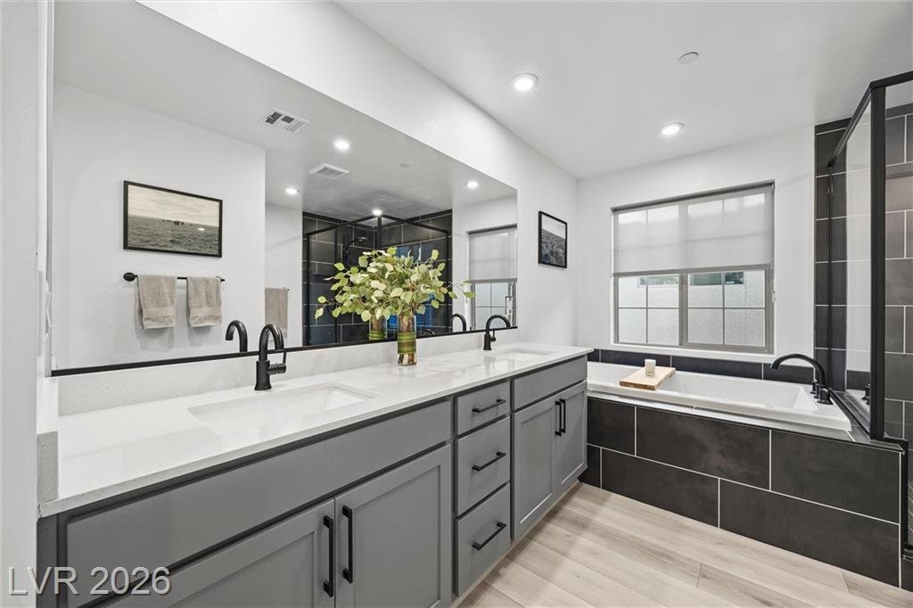 Primary bath at 2702 Marchetti Place with dual sinks and a garden tub