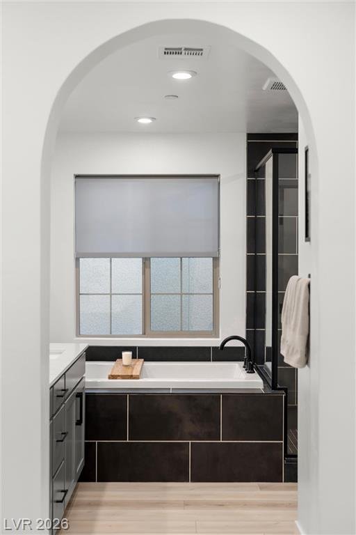 Arched alcove framing the primary garden tub