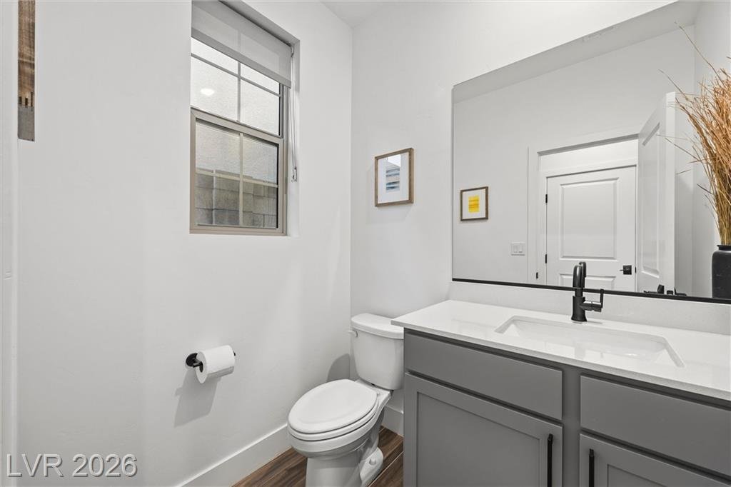 Powder room with a gray vanity and quartz counter