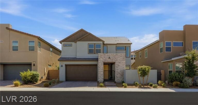 Front of 3233 Waterstone Avenue, a two-story Inspirada home with a stone entry tower and two-car garage