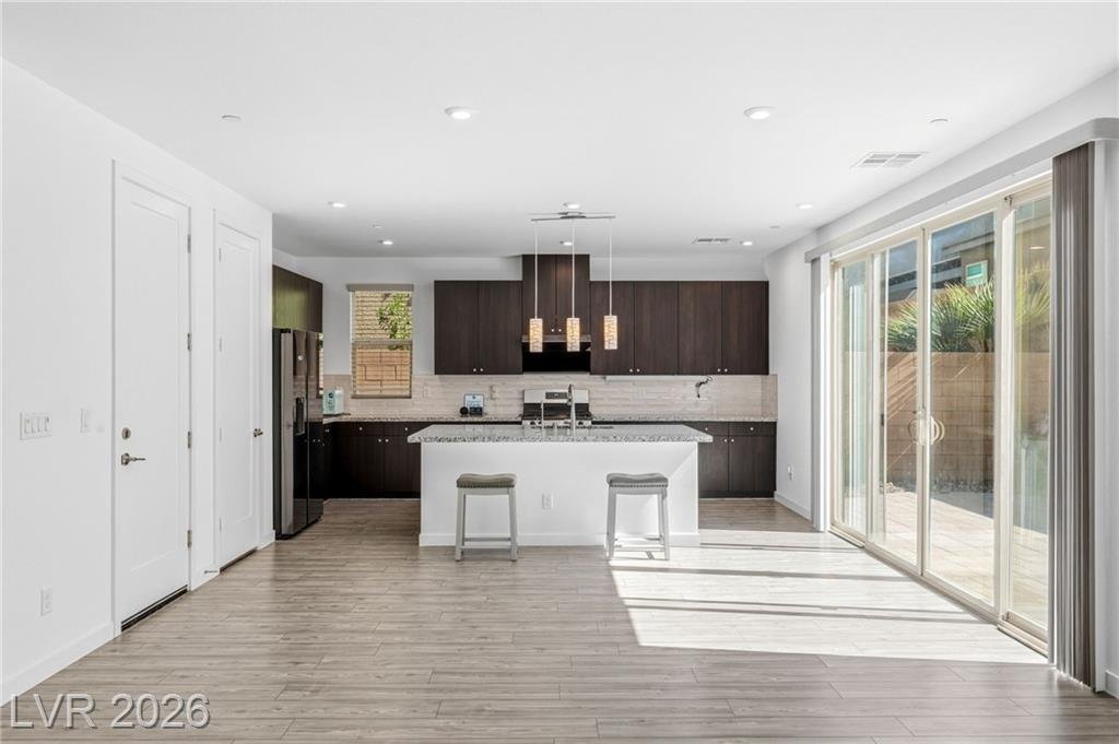 Kitchen with center island beside the 12-foot center-opening sliding glass door