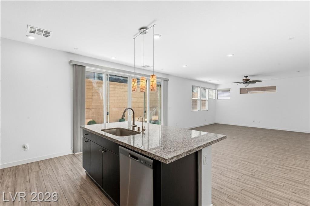 Granite island with pendant lights looking across to the family room