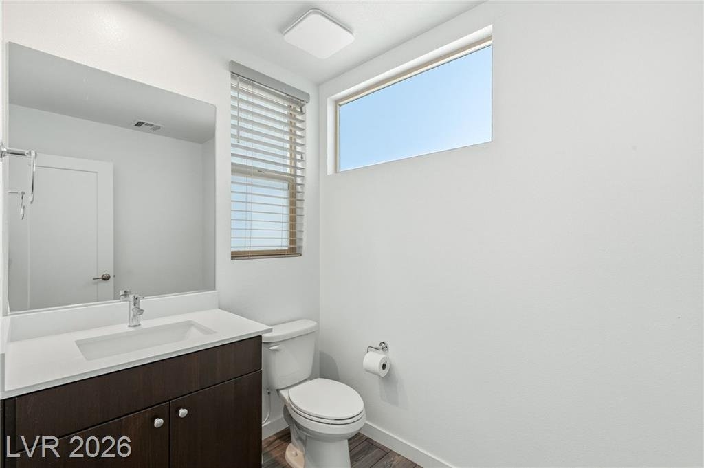 Downstairs powder room with a white quartz vanity