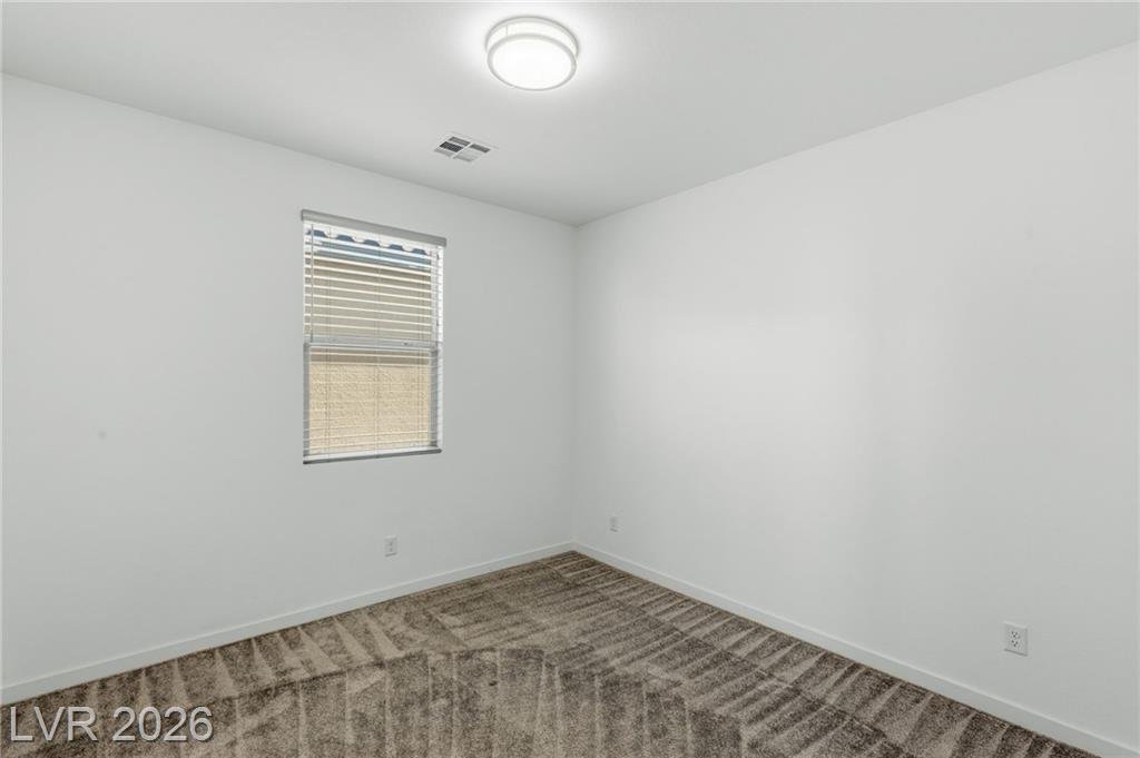 Third bedroom at 3233 Waterstone Avenue with a window and closet wall