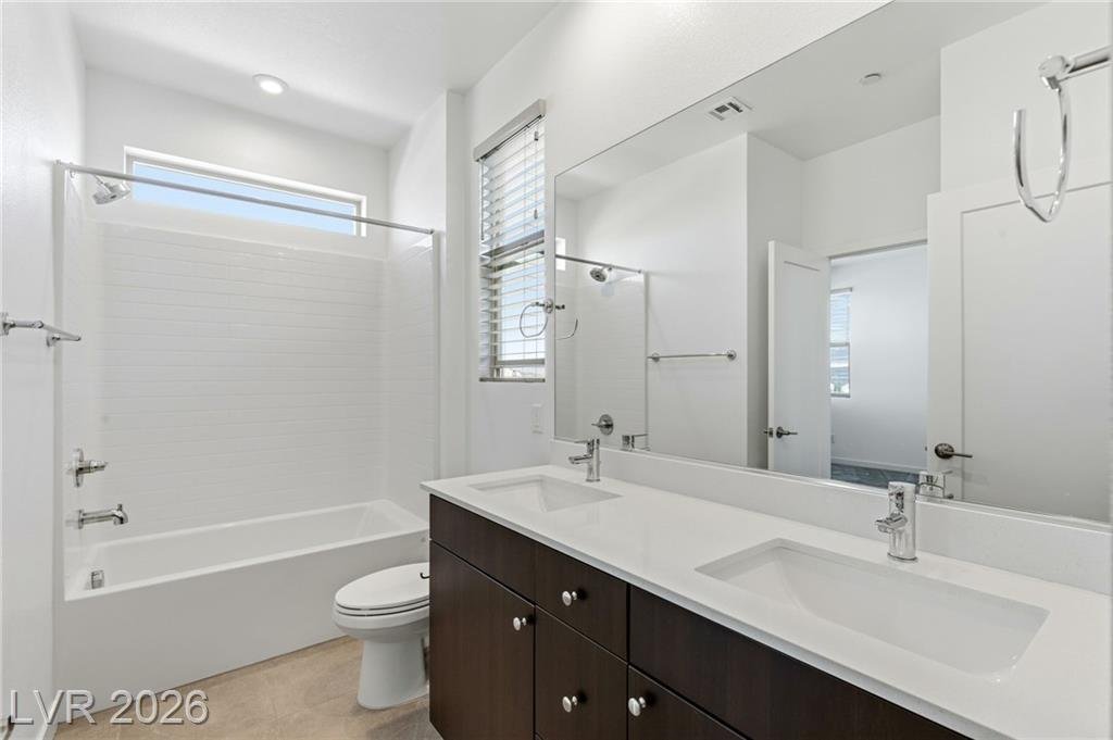 Jack-and-Jill bath with double sinks and tub-shower combination
