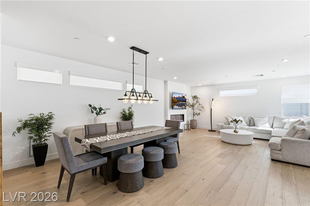 Open dining and great room with hardwood floors at 3263 Fountaintree Avenue