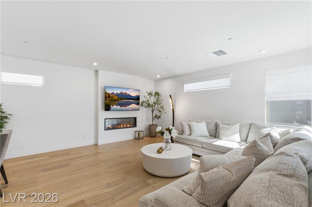 Linear electric fireplace set below the TV wall in the great room at 3263 Fountaintree Avenue