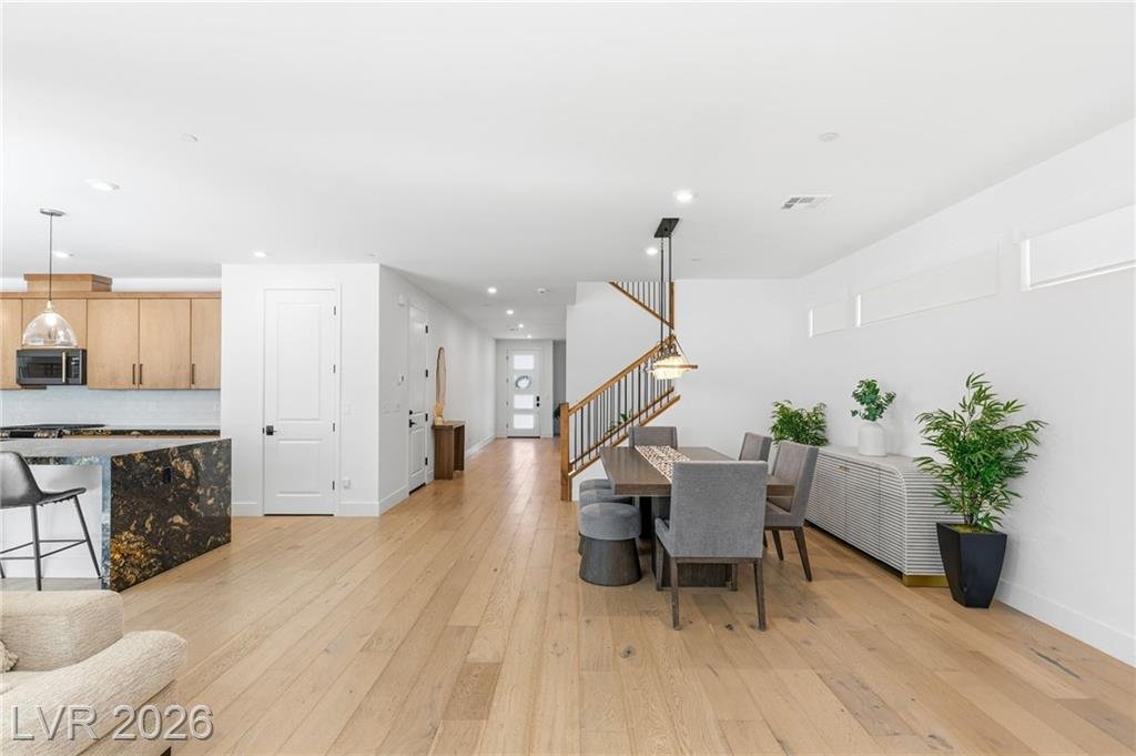 Open main floor from the kitchen through to the front entry at 3263 Fountaintree Avenue