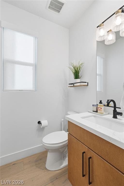 Downstairs powder room with wood vanity and black fixtures