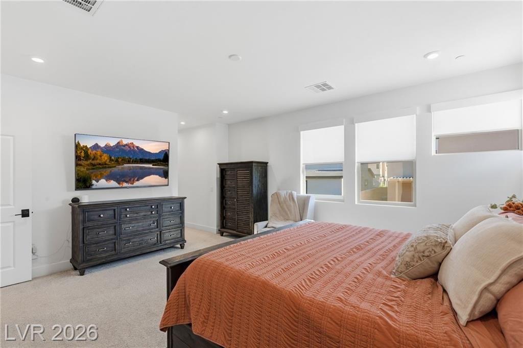 Primary bedroom with clerestory windows above the dresser wall
