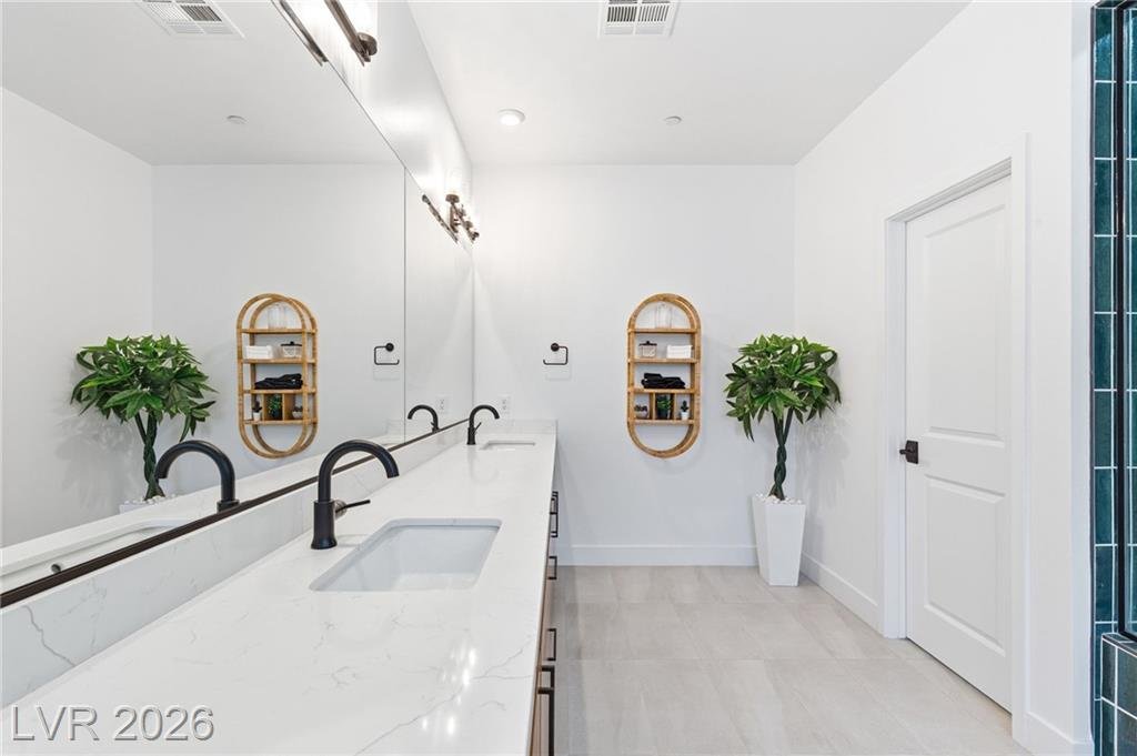 Long primary vanity with undermount sinks and matte black faucets