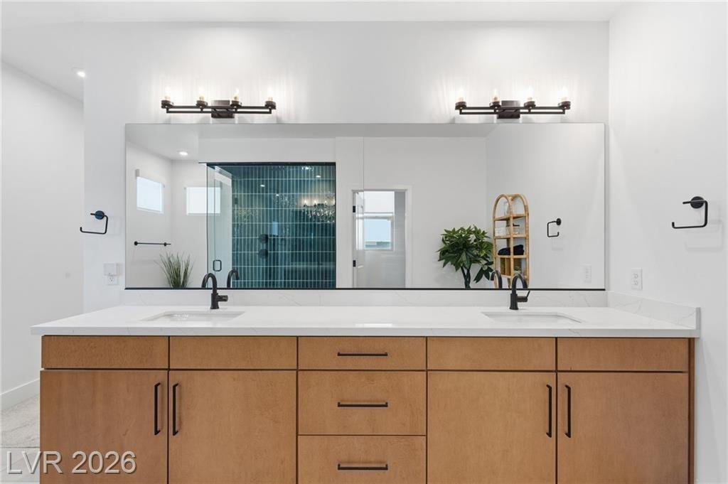 Double vanity mirror reflecting the emerald tile shower