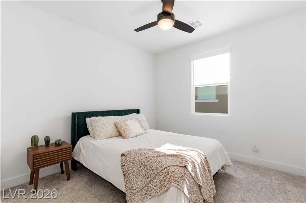 Third bedroom with ceiling fan and carpet