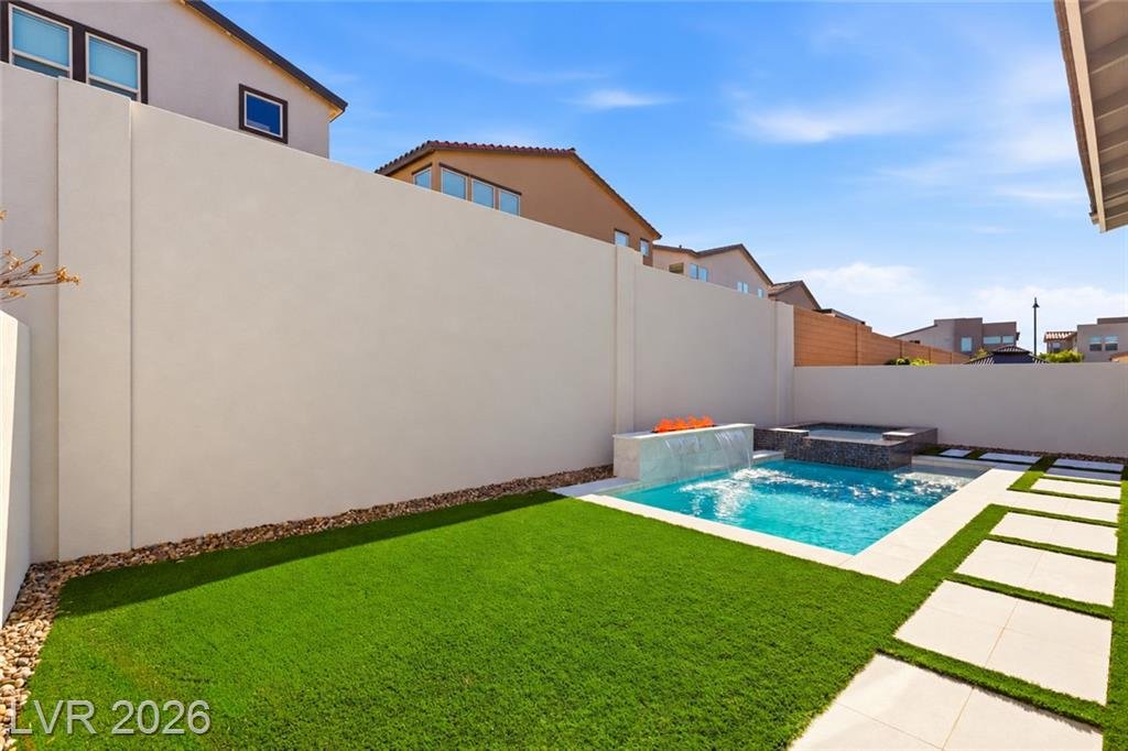 Backyard with turf, concrete pavers and pool at 3263 Fountaintree Avenue