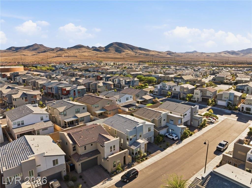 Aerial over Inspirada rooftops toward the mountains