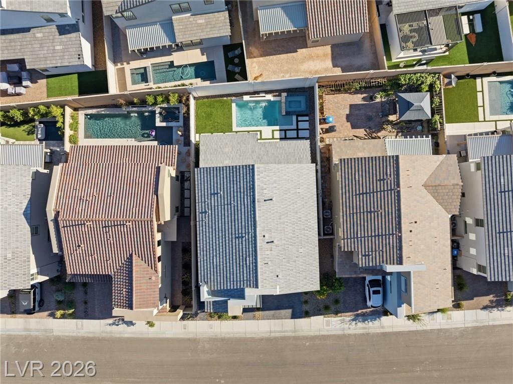 Overhead aerial showing the backyard pool and turf from above