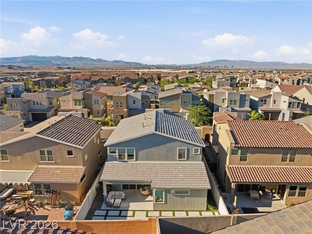 Aerial of the back of the home with the covered patio and pool