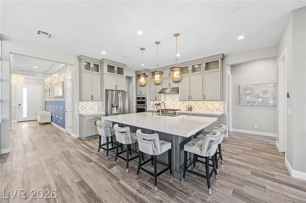 Kitchen island with bar seating and gold pendant lights