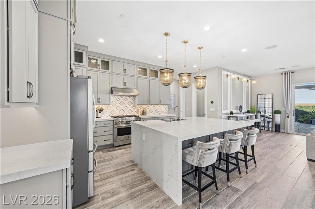 Waterfall quartz island and stainless refrigerator