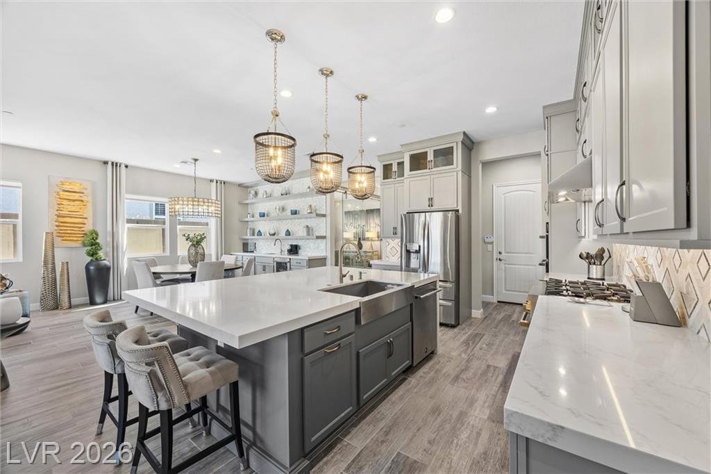 Island sink, dark lower cabinets and a quartz prep counter
