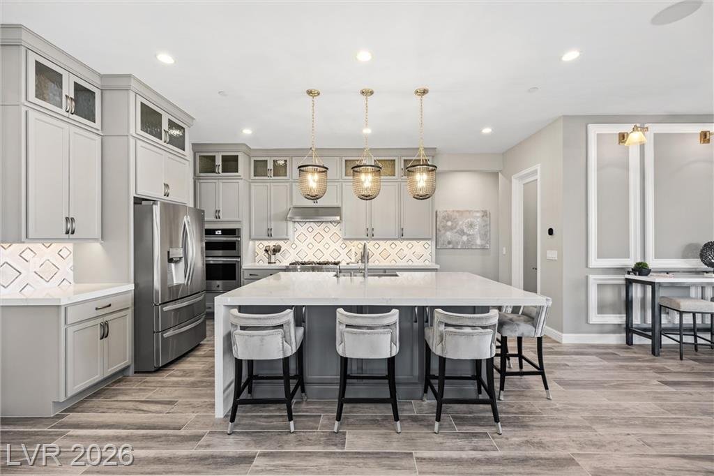 Chef's kitchen at 3382 Spring Rock Avenue with a large waterfall island