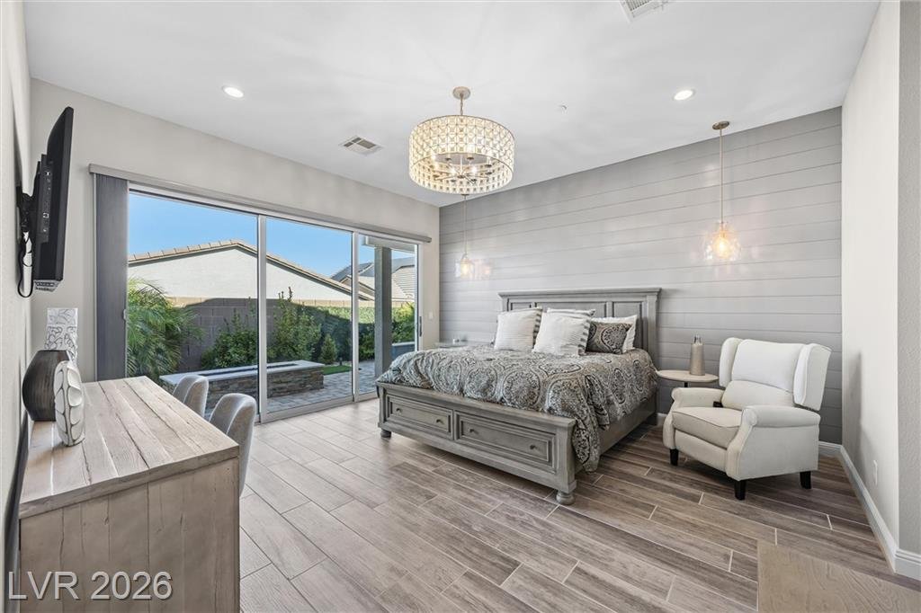 Primary suite with a drum chandelier and backyard access