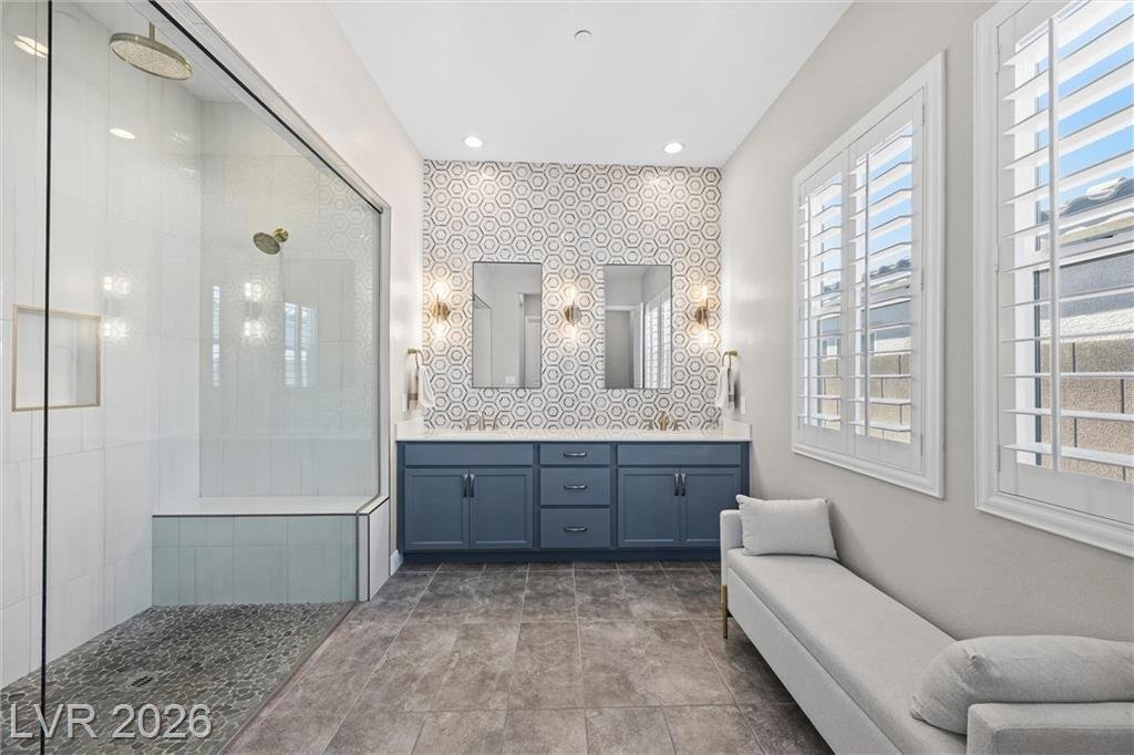 Primary bath with double sinks and a hexagon tile accent wall