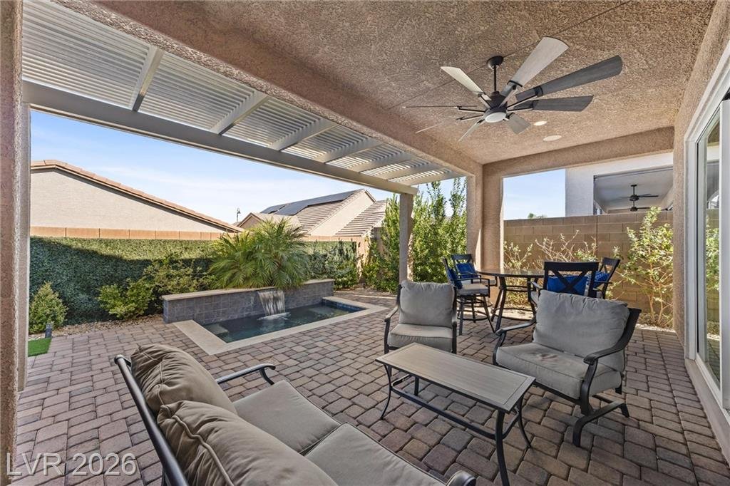 Patio lounge seating looking out to the spa and palm
