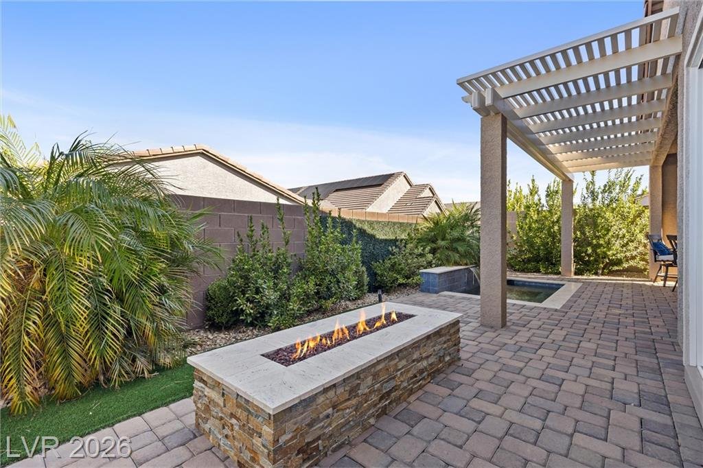Pergola, turf strip and linear fire pit