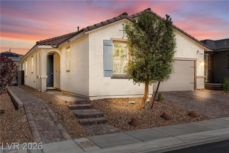 Twilight view of 3500 Brezine Avenue, a single-story Inspirada home with a tile roof and lit paver walkway