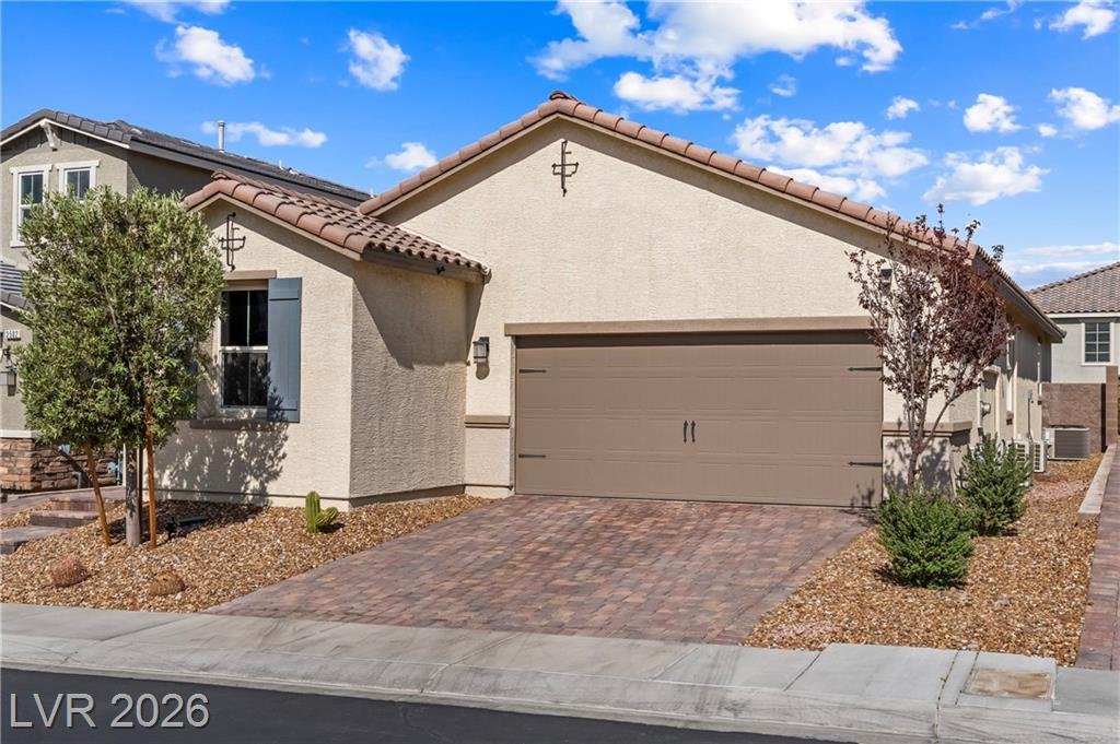 Two-car garage and paver driveway on a single-story Inspirada home