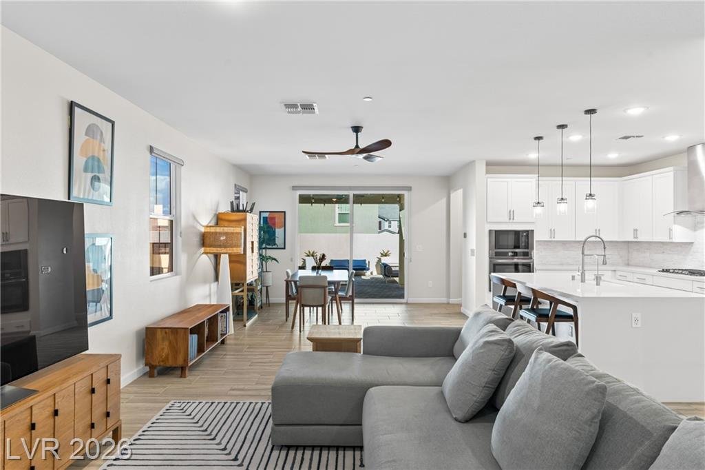 Open great room at 3500 Brezine Avenue looking toward the dining area and slider
