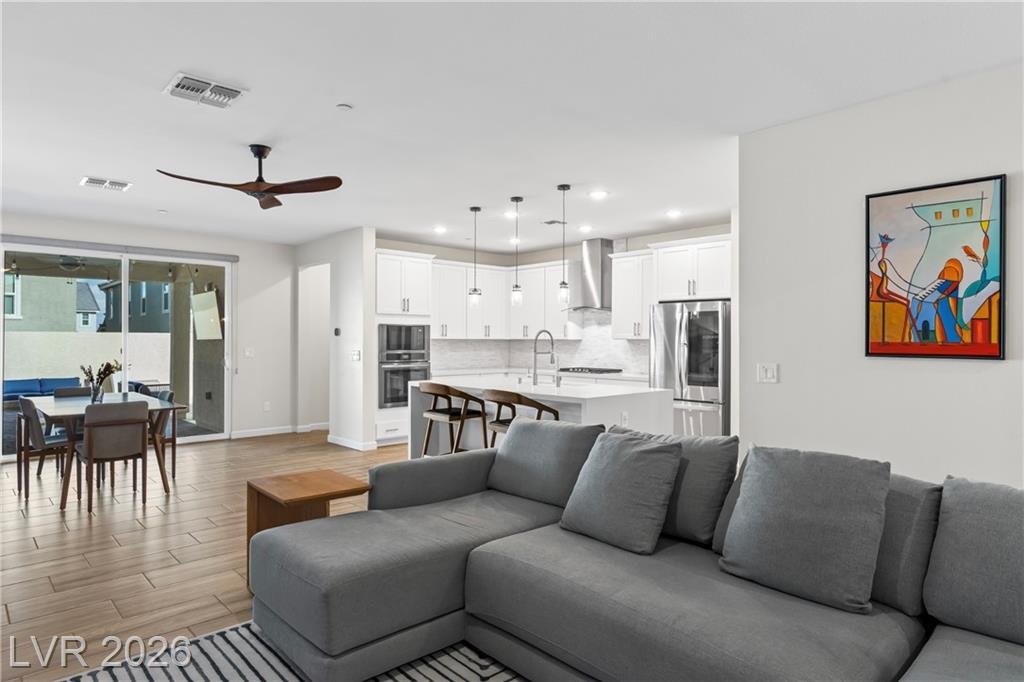 Living area flowing into the kitchen island and dining table