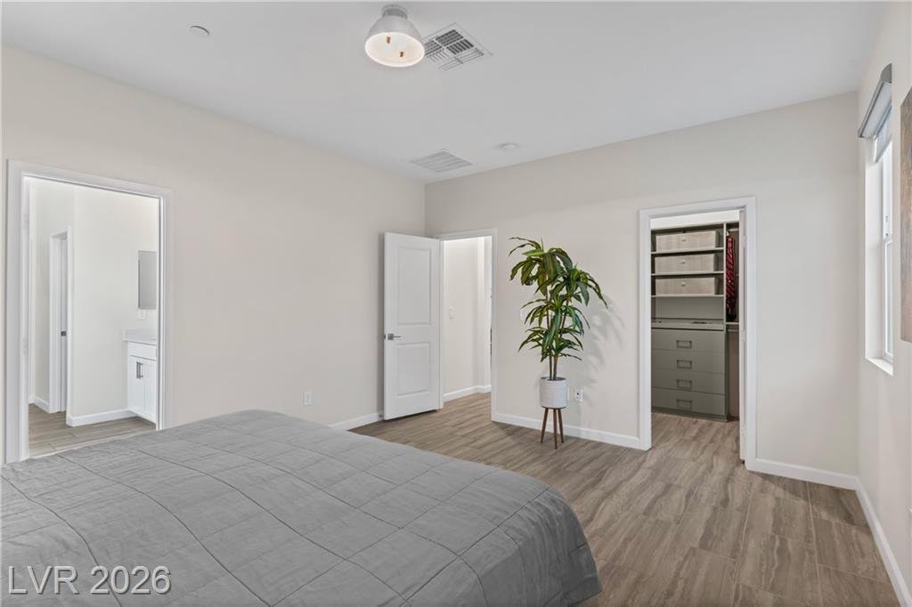 Primary bedroom at 3500 Brezine Avenue with doors to the bath and walk-in closet
