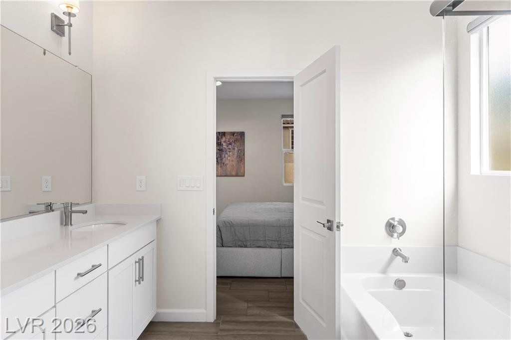 Primary bath with a soaking tub and quartz vanity