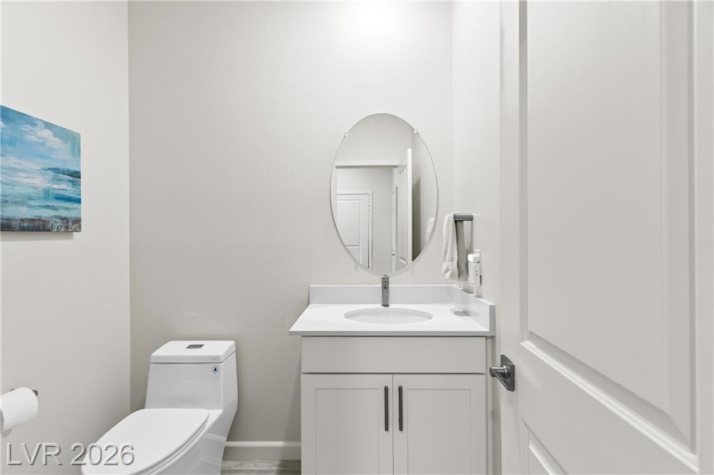 Half bath with an oval mirror and new toilet