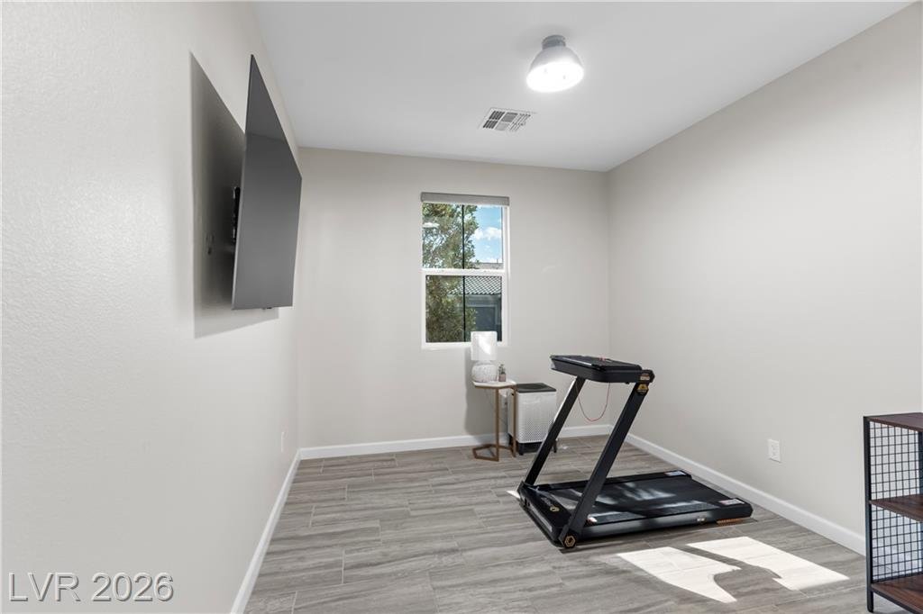 Flex bedroom set up as a home gym with a treadmill