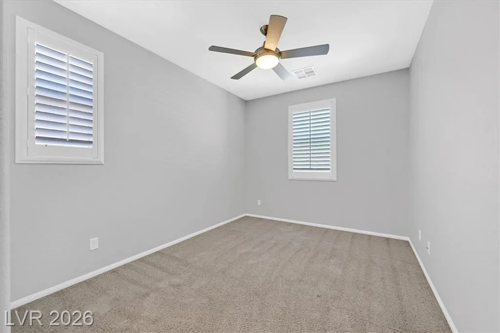 Secondary Bedroom - 3193 Brescia Bank Ave Inspirada 3193 Brescia Bank Ave Henderson NV - Bright Bedroom with Ceiling Fan and Shuttered Windows | Inspirada Home for Sale