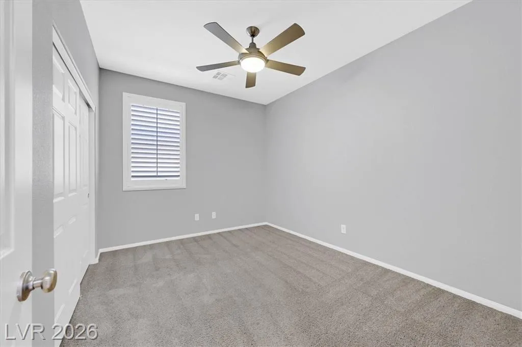 Master Bedroom - 3193 Brescia Bank Ave Inspirada 3193 Brescia Bank Ave Henderson NV - Spacious Bedroom with Carpet, Ceiling Fan and Shutters | Inspirada Home for Sale