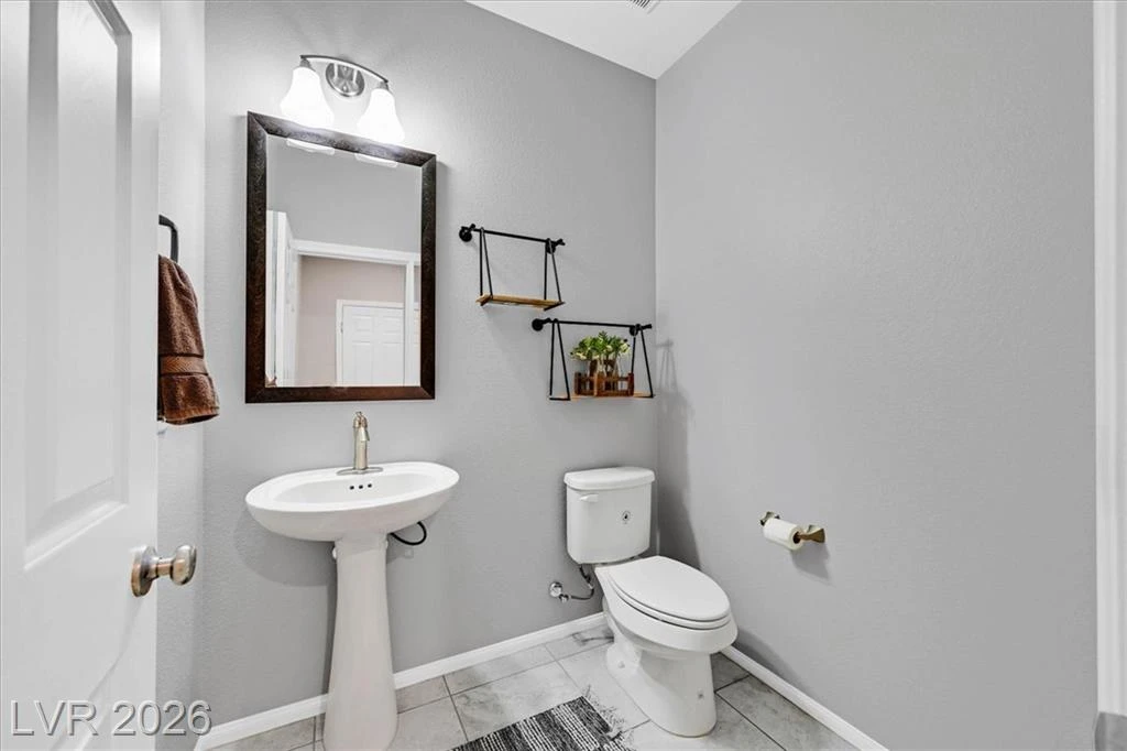 Guest Bathroom - 3193 Brescia Bank Ave Inspirada 3193 Brescia Bank Ave Henderson NV - Guest Bathroom with Pedestal Sink and Toilet | Inspirada Home for Sale